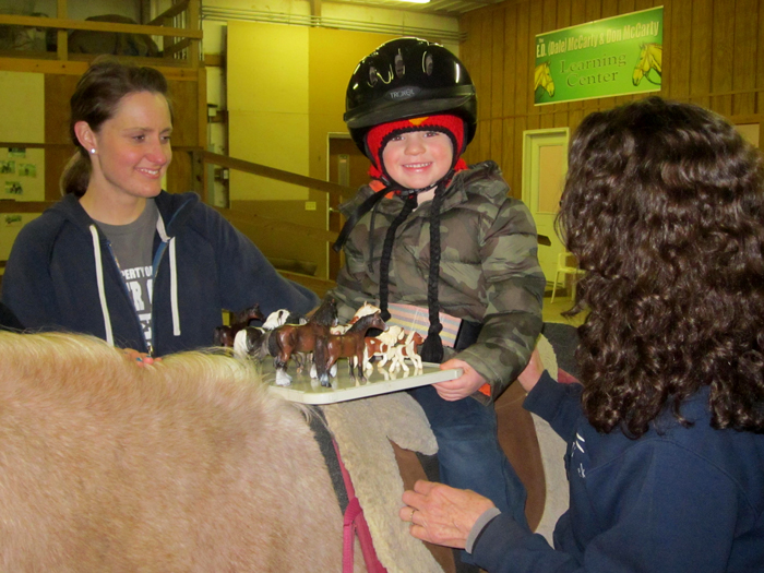 Zach smiling while sitting on a horse