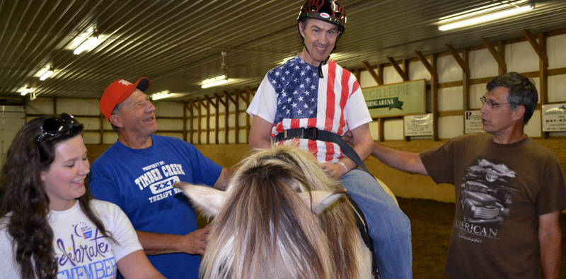 Staff assisting in therapeutic riding.